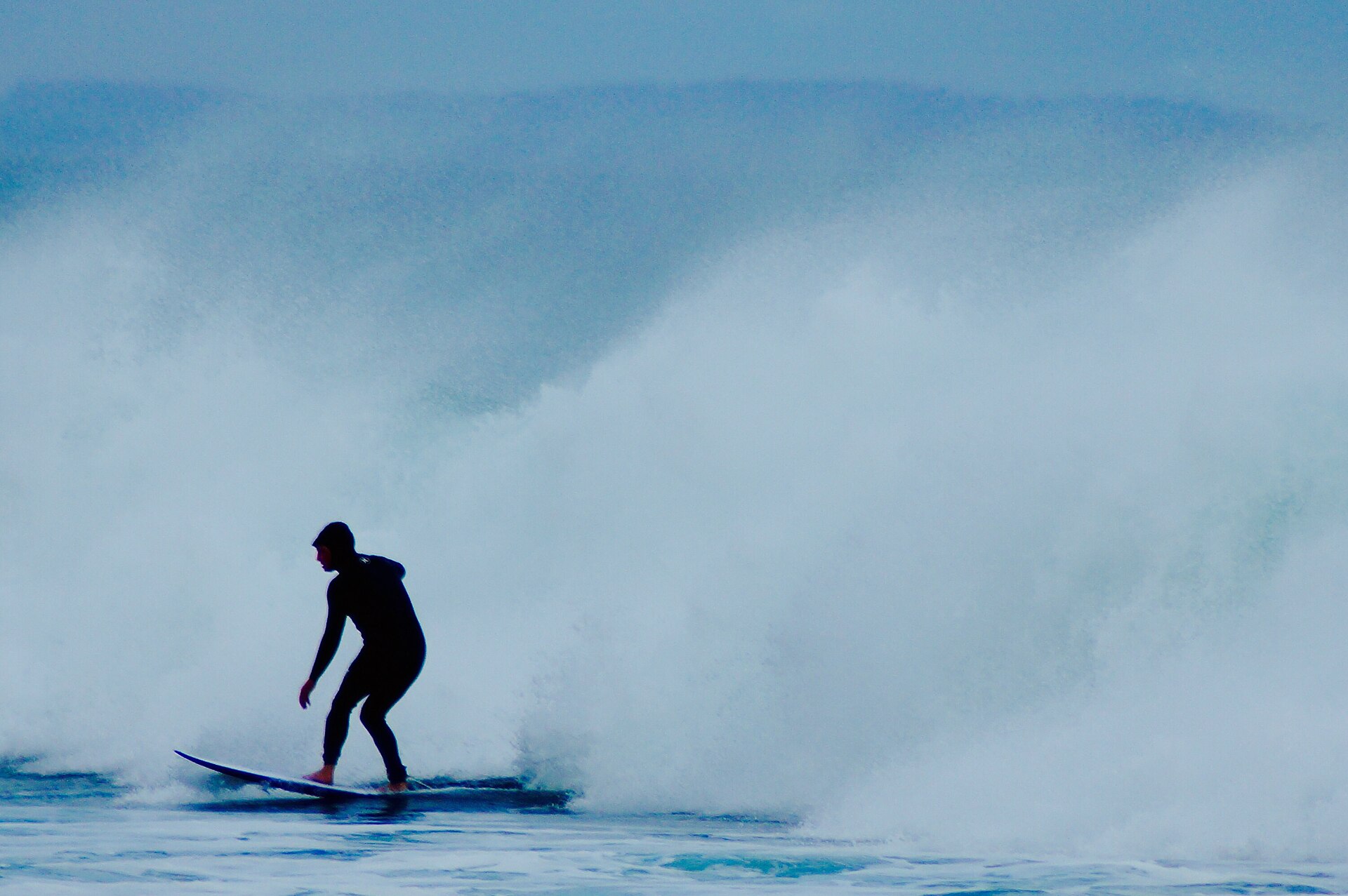 Rider in the surf (Unsplash)